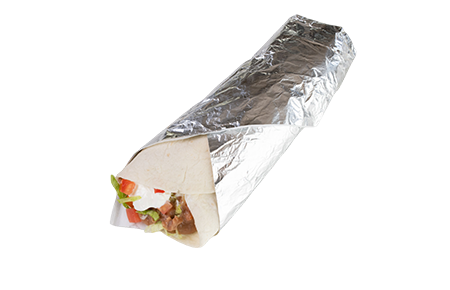 A burrito wrapped in foil with vegetables.