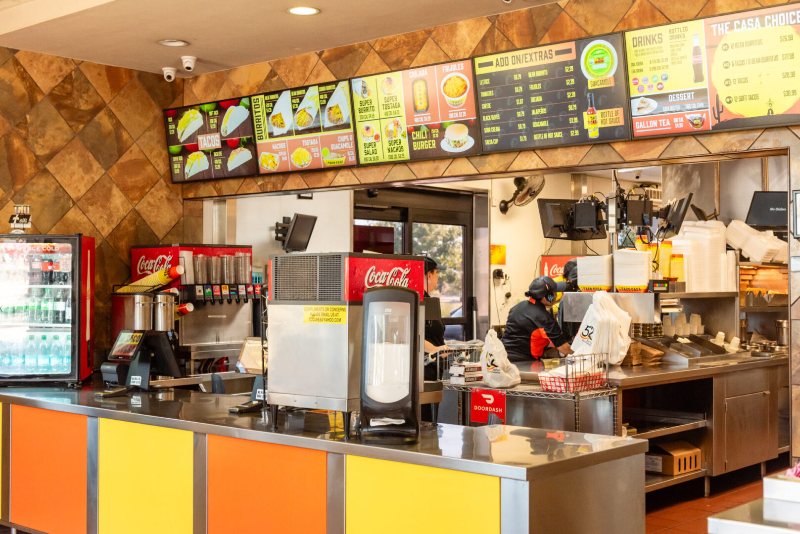 A restaurant with many different types of food on the counter.